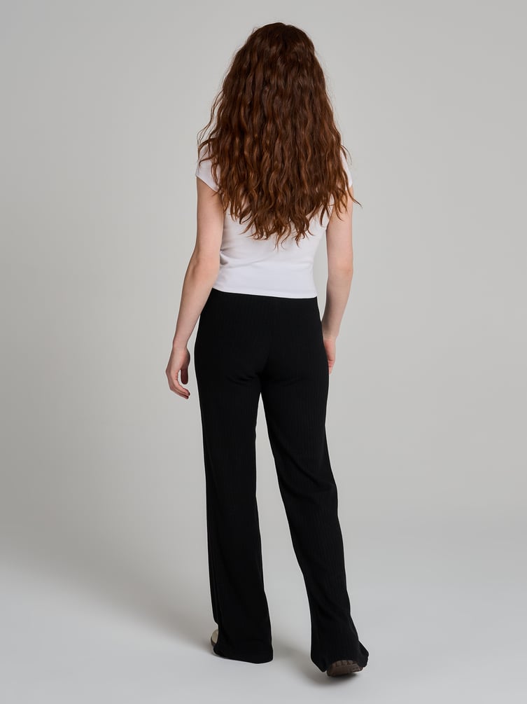 Брюки клеш от колена в рубчик