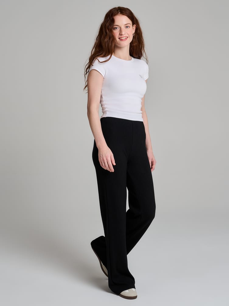 Брюки клеш от колена в рубчик