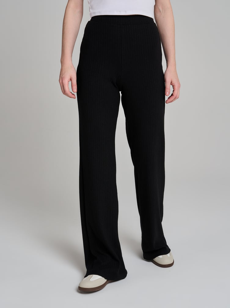 Брюки клеш от колена в рубчик